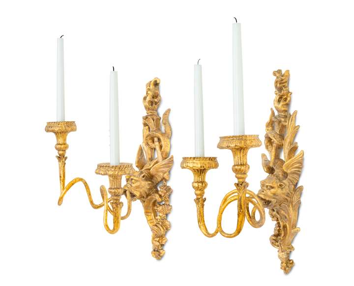 A pair of late baroque iron and giltwood two lights wall sconces